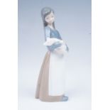 A Lladro figurine of a girl holding a piglet, 18 cm