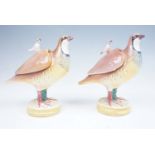 A near pair of Spanish Alcora faience sauce tureens in the form of partridges, the lift off covers
