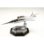 A 1950s chromium plated novelty petrol table lighter in the form of a fighter aircraft, on a stand