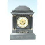 An early 20th Century architectural black slate mantle clock, having a French drum movement with a