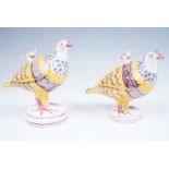 A near pair of Spanish Alcora faience sauce tureens in the form of partridges, the lift off covers