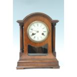 An early 20th Century German mantle clock, with brass movement, striking on a gong, domed top and