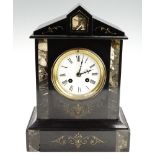 An early 20th Century black slate mantle clock, having a French drum movement with a pendulum