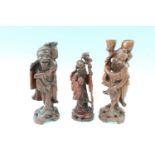 Two Chinese carved wood figural lamp bases, together with another similar in depiction of the