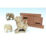 An Indian puzzle box, having three secret compartments, together with a carved figure of a beast and