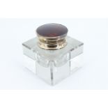 A George VI tortoiseshell and silver mounted glass inkwell, the polished crystal body having