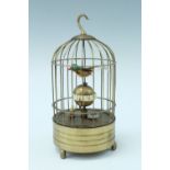A 1950s brass bird cage automaton alarm clock, clockwork movement, keyless wind and alarm set