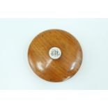 A late Victorian turned oak snuff box, of drum form with domed slip-lid, the latter bearing an inset