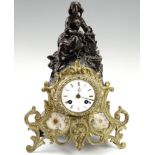 A 19th Century French figural mantle clock, having a drum movement with a pendulum striking on a