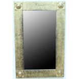 An Art Deco brass framed wall mirror, formed as a wooden frame with an embossed brass covering,