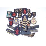 A quantity of Royal Navy cloth insignia including a Combined Operations badge