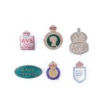 A Women's Land Army cap badge together with a silver ARP badge, a WRVS Trainer enamelled lapel and