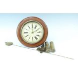 A Victorian postman's alarm clock, brass and wood movement with a gessoed and painted circular