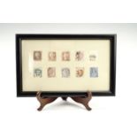 A framed display of Victorian postage stamps, 23 cm x 14.5 cm
