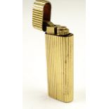 A vintage Cartier gold plated cigarette lighter