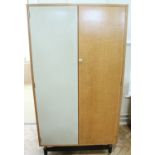 A 1960s Gomme G-Plan three-piece bedroom suite, comprising a wardrobe, chest of drawers and