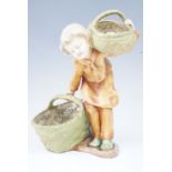 A 1950s - 1960's kitsch figurine of a young girl carrying baskets, 27 cm, (a/f)