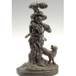 A Victorian cast iron door porter in the form of a woodsman and his hound, 38 cm