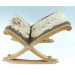 An old reproduction tapestry-upholstered giltwood gout stool