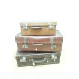 A vintage dark brown hide suitcase retaining its original key, (62 cm x 39 cm x 19 cm), together
