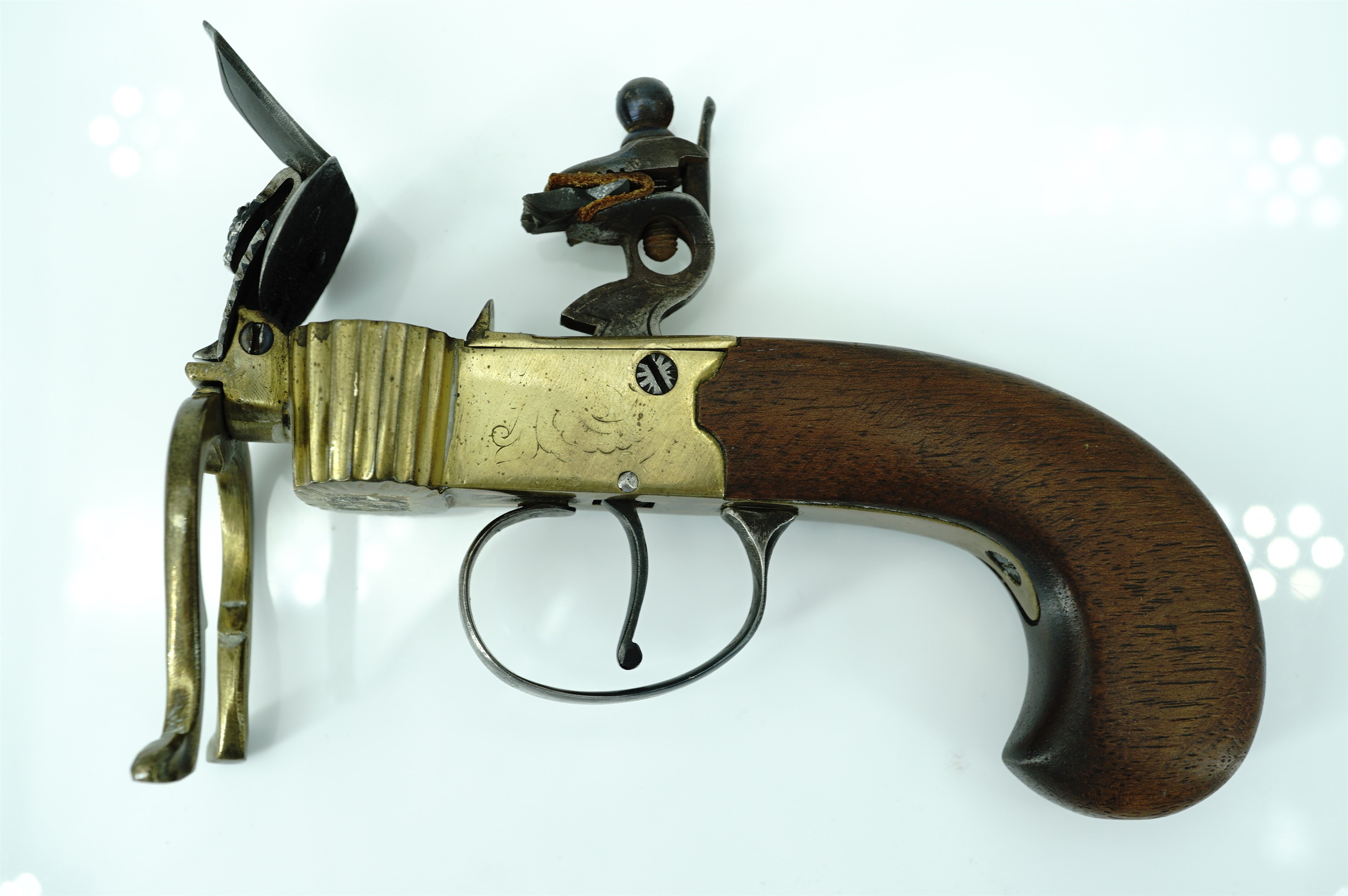 A flintlock tinder box candle lighter, having a brass body with steel cock and frizen on a walnut - Image 4 of 7