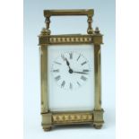 An early 20th Century brass carriage clock, the case having fluted corners with pyramid frieze to