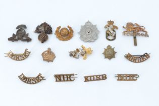 A small group of British army cap and other badges including a Lancashire Fusiliers officer's