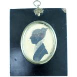 An early 19th Century portrait profile silhouette of a lady, in black with white watercolour and