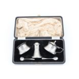 A cased Edwardian three piece capstan shaped silver condiment suite, comprising pepperette, salt