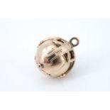 A gilt white metal Masonic metamorphic orb fob, being a ball which opens out to form a cross with