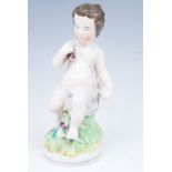 A late 19th Century Staffordshire figurine of a putto, 23.5 cm