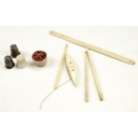 A selection of 19th Century sewing items comprising a bone thread bobbin, crochet hooks, a pin