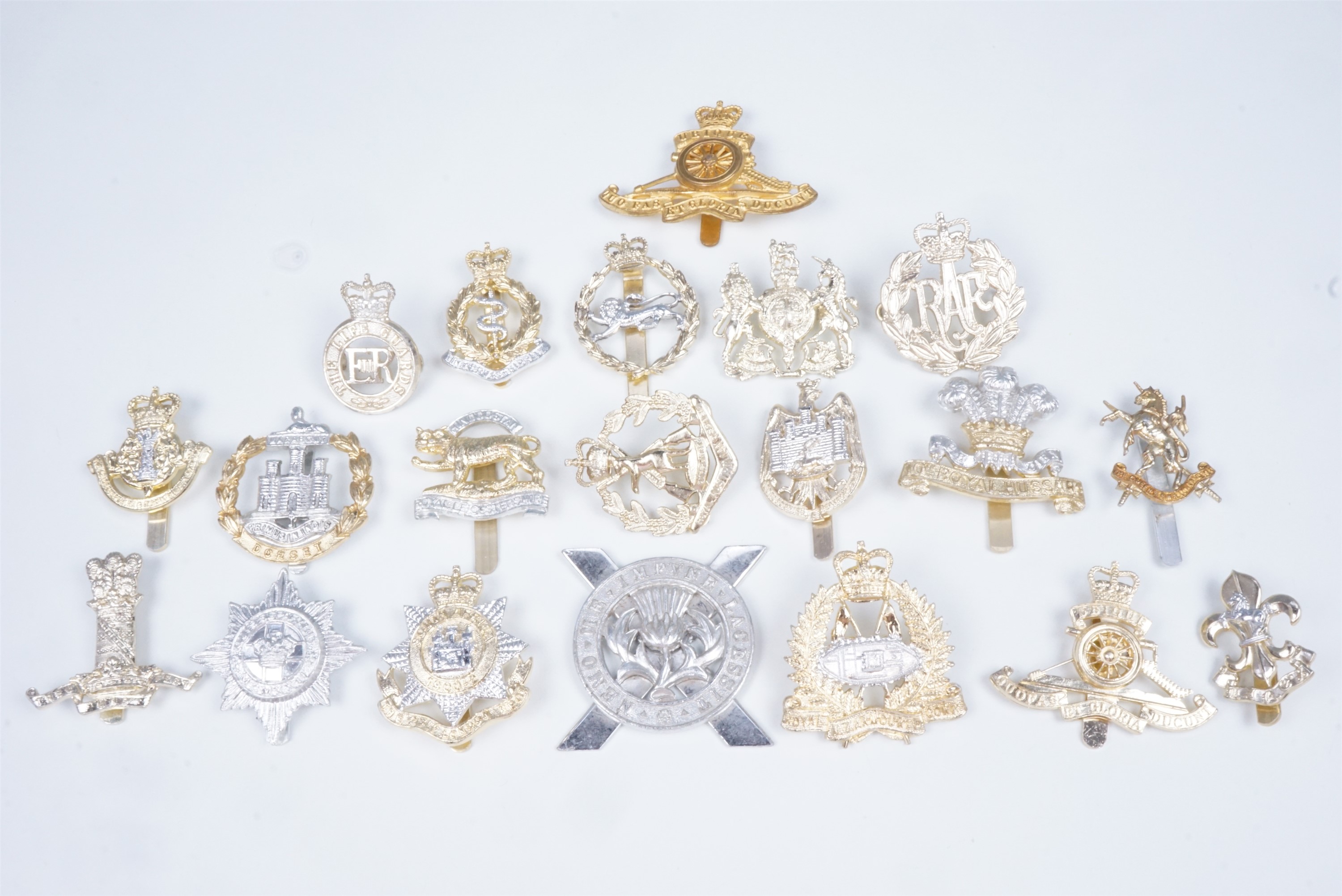 A quantity of British Army Staybrite cap badges, etc