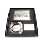 A boxed three piece "Coca-Cola" cigarette gift set, comprising a flip-top petrol lighter, a