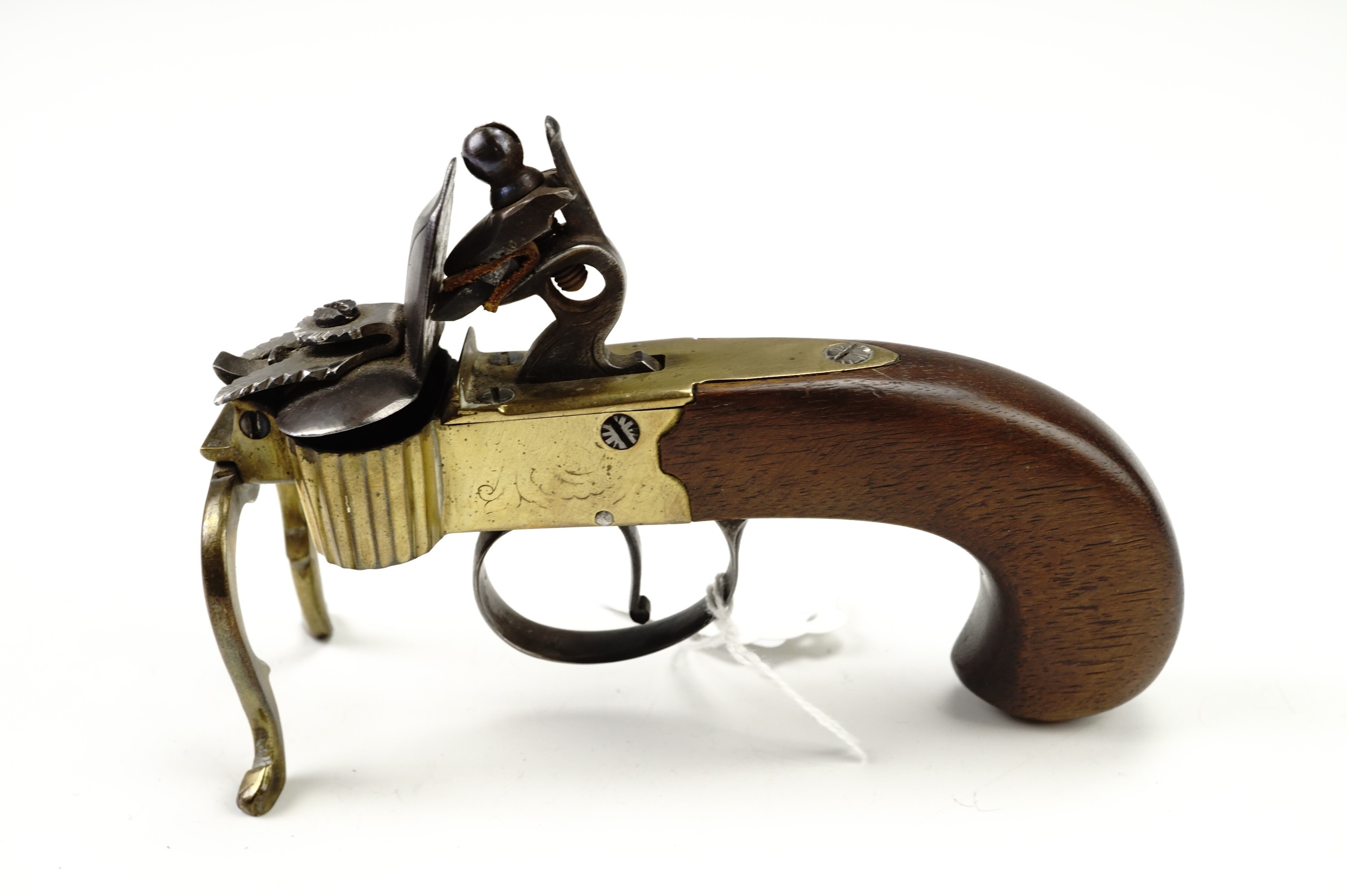 A flintlock tinder box candle lighter, having a brass body with steel cock and frizen on a walnut