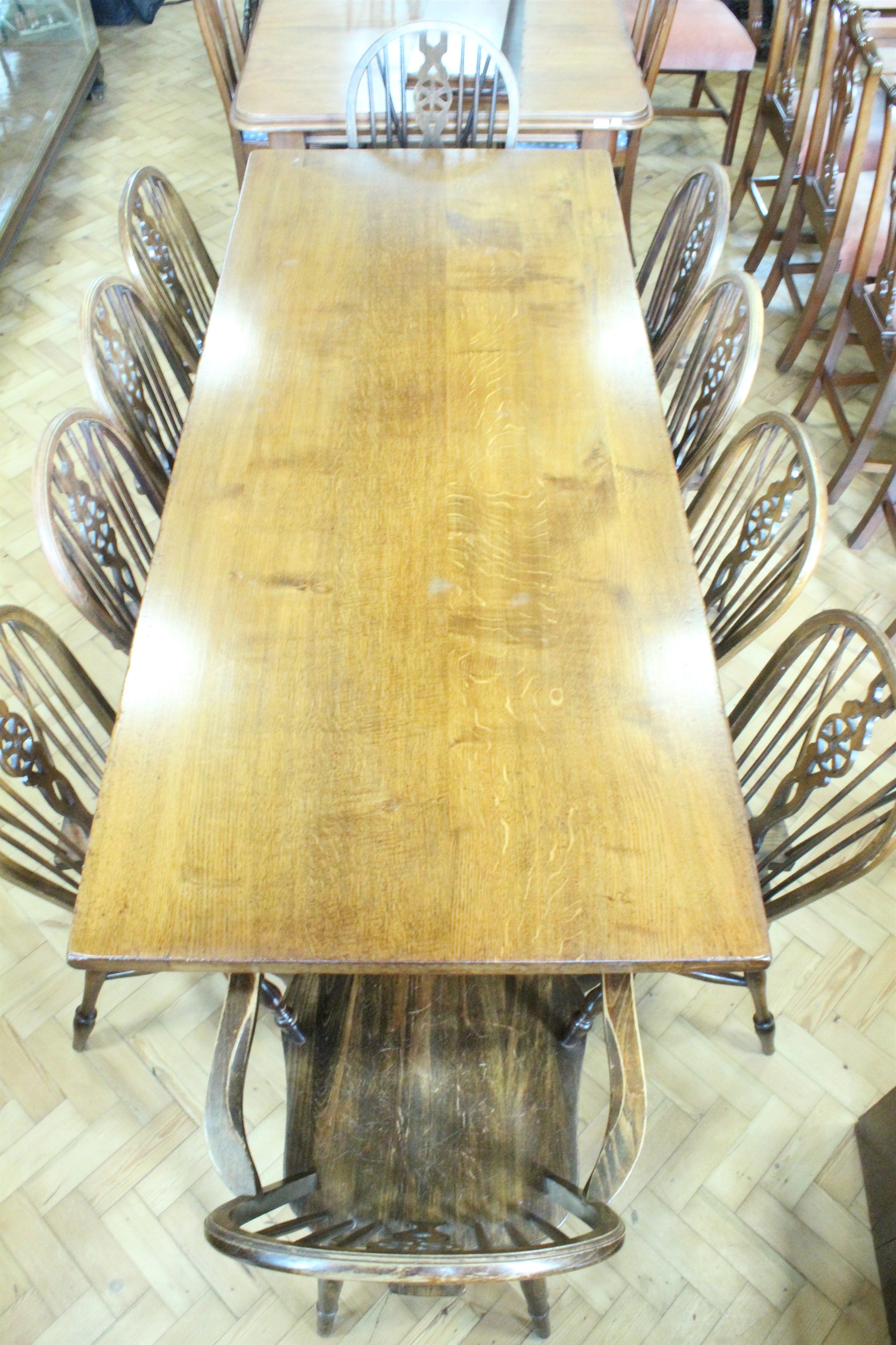 A reproduction oak refectory dining table together with ten Windsor chairs