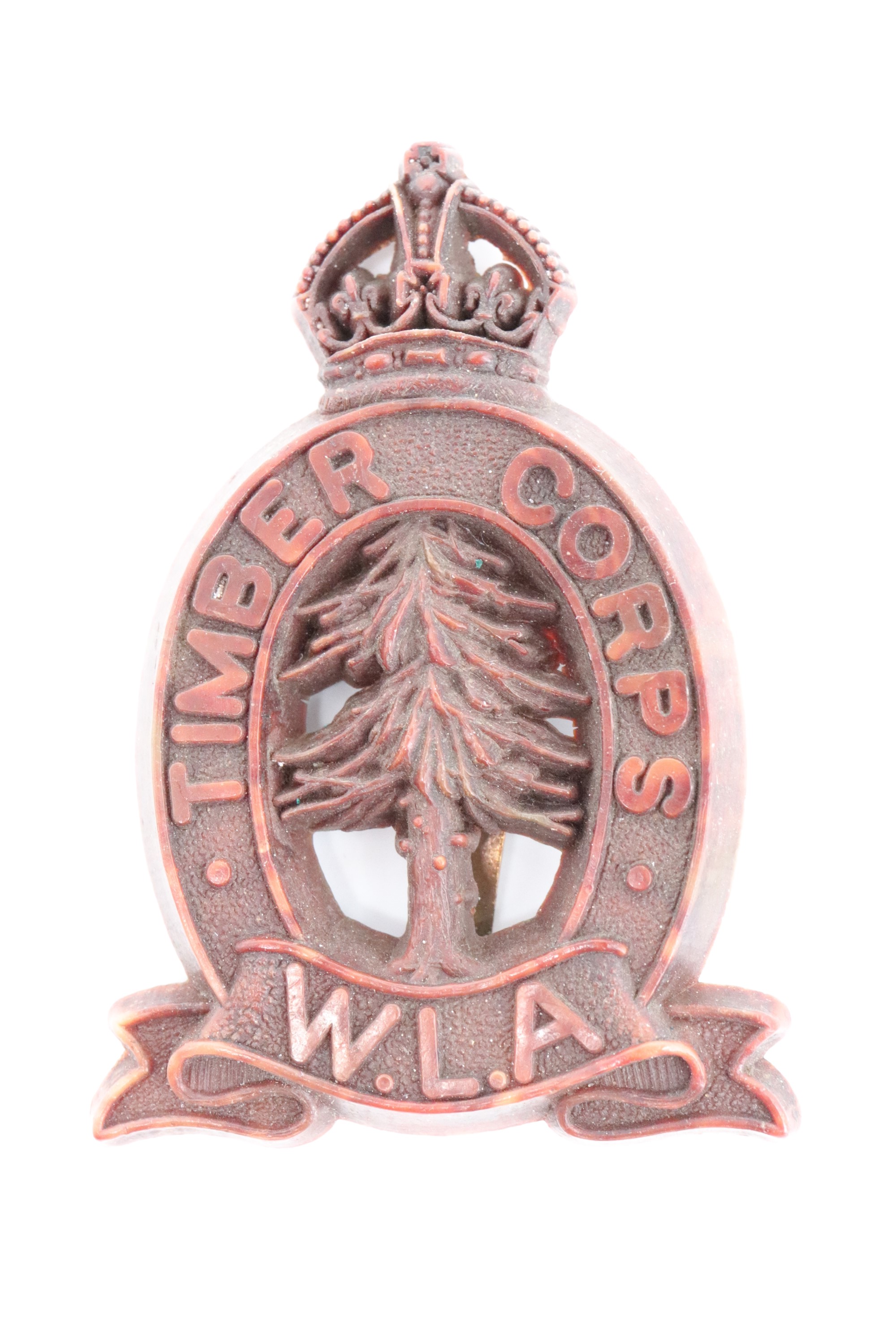 A Second World War Women's Land Army Timber Corps plastic cap badge