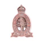 A Second World War Women's Land Army Timber Corps plastic cap badge