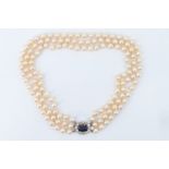 A fine vintage triple strand pearl necklace, comprising pearls of approximately 8 mm on knotted silk