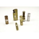 A small group of vintage brass wheel cigarette lighters, including a novelty miners lamp form gas