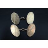 A pair of white and yellow metal cufflinks, engine turned oval fronts, marked "9ct gold and silver",