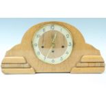 A 1950s Moderne bird's eye maple mantle clock, having a German movement with a pendulum