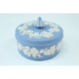 A Wedgwood blue Jasperware circular covered trinket box, late 20th Century, 13 cm diameter