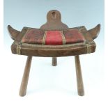 An early-to-mid 20th Century Middle Eastern style upholstered pine stool, 61 cm x 35 cm x 41 cm