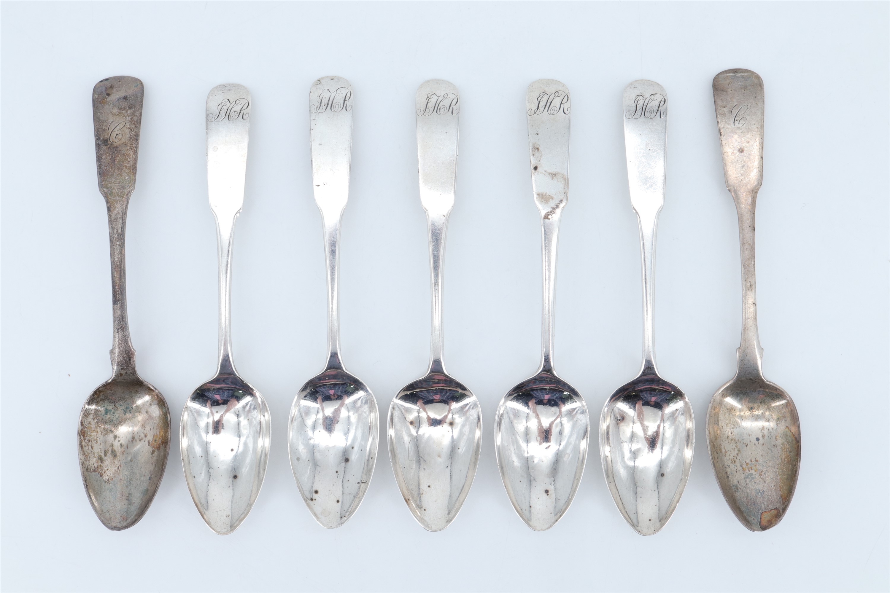 Seven 19th Century Scottish silver fiddle pattern teaspoons, comprising five spoons bearing
