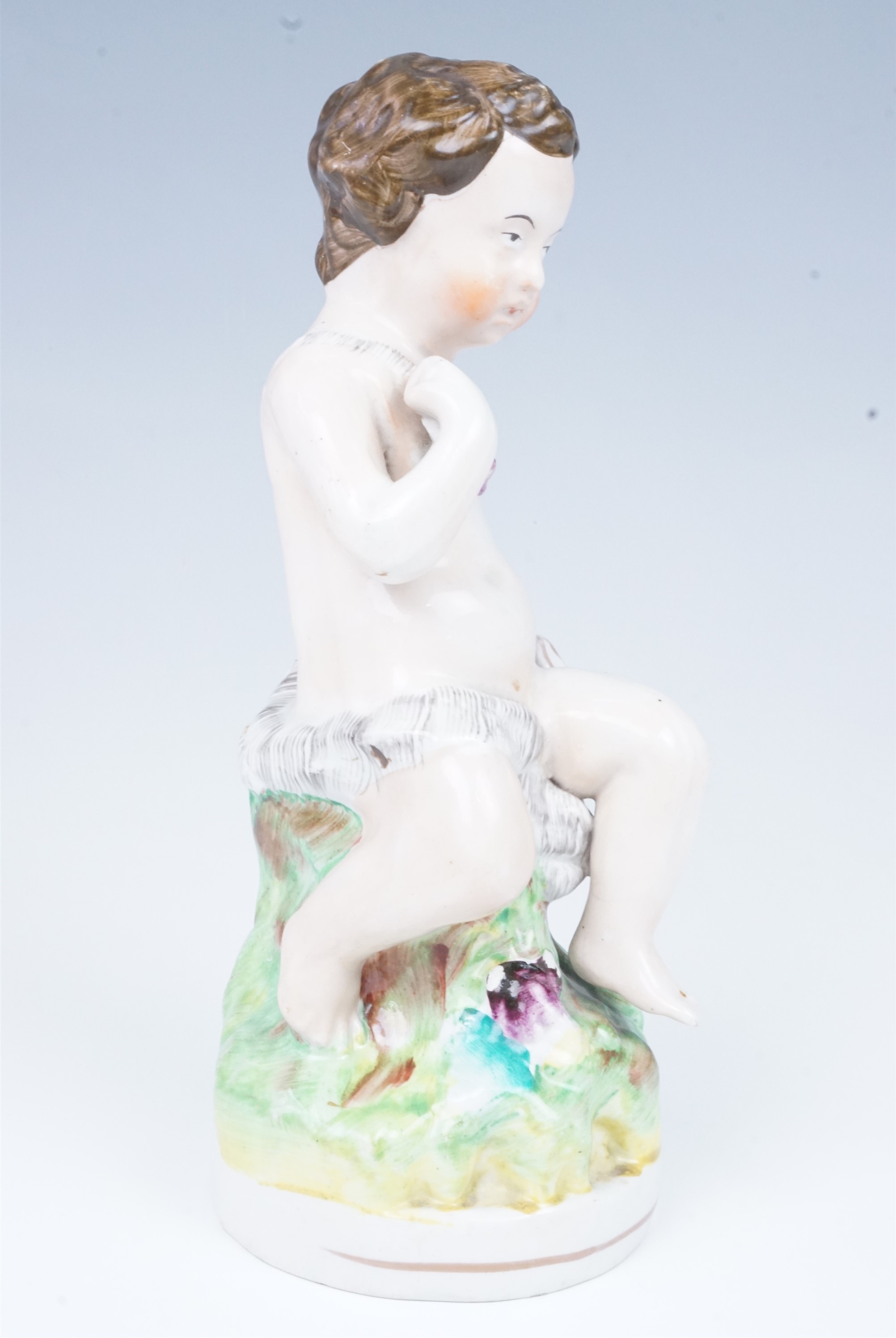 A late 19th Century Staffordshire figurine of a putto, 23.5 cm - Image 2 of 4