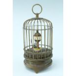 A 1950s brass bird cage automaton clock, having a keyless wind mechanical moment, an Arabic orbital