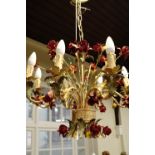 A naturalistic eight arm chandelier, having sprays of red roses and leaves scrolling around the