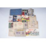 A quantity of cigarette card albums, tea card albums and loose cigarette cards