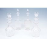 A pair of Victorian heavy cut glass baluster decanters, together with two later Victorian /